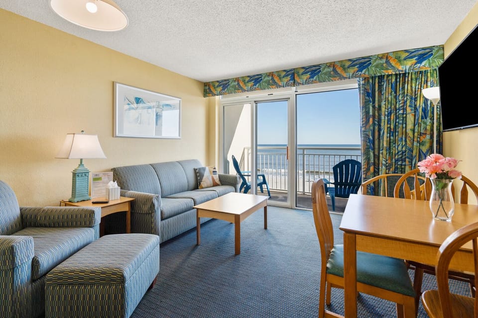 Sectional seating and wide ocean views at Bay Watch I 408, a 2-bedroom Crescent Beach condo rental