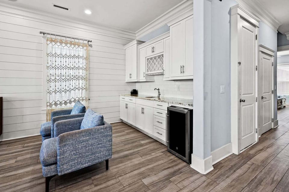 Blue chairs and a beverage fridge in the living area at Ocean Current, Cherry Grove, North Myrtle Beach