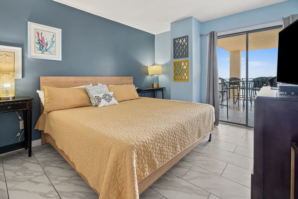 Bedroom opening to the balcony with an ocean view at Xanadu III 602, a 2-bedroom Ocean Drive vacation rental