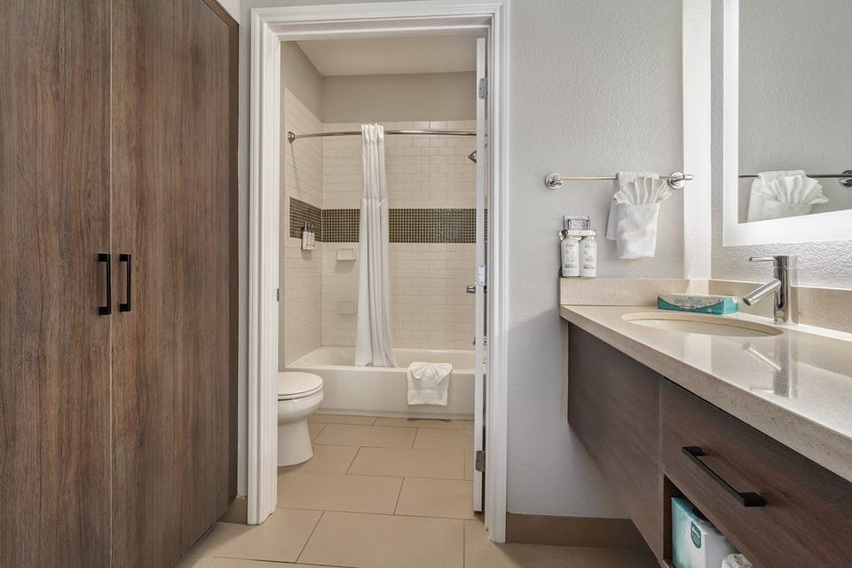 Fresh and functional bathroom space, showcasing sleek finishes and abundance of natural light.
