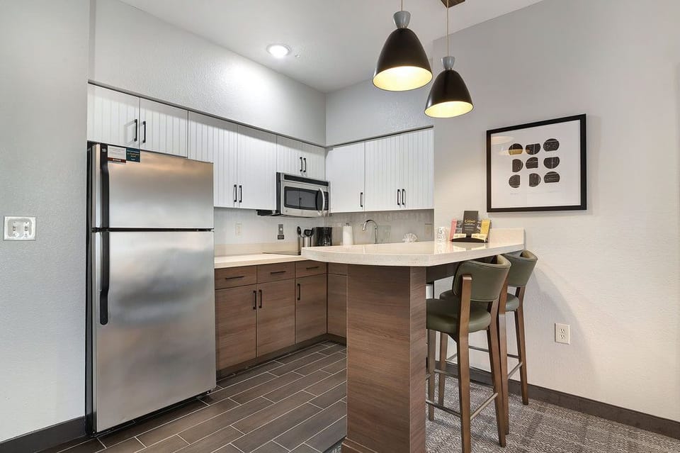 Whip up your favorite meals in a stylish kitchen featuring modern appliances and sleek countertops.