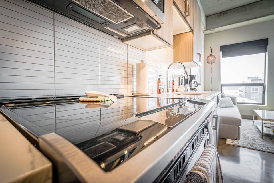 Your sleek kitchen awaits with premium appliances and modern design, perfect for preparing meals while enjoying city views.