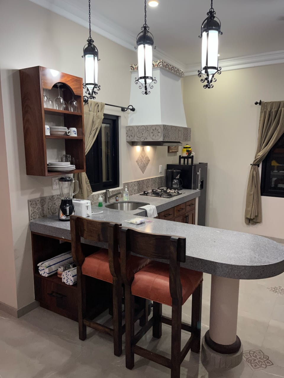 Island style kitchen with sitting bar stools