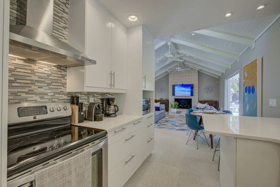High end kitchen stocked with dishes, glasses, pot and pan, etc.