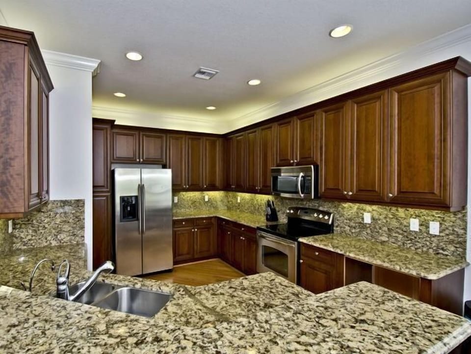 Granite throughout and under-cabinet and over-cabinet lighting. Hardwood floors
