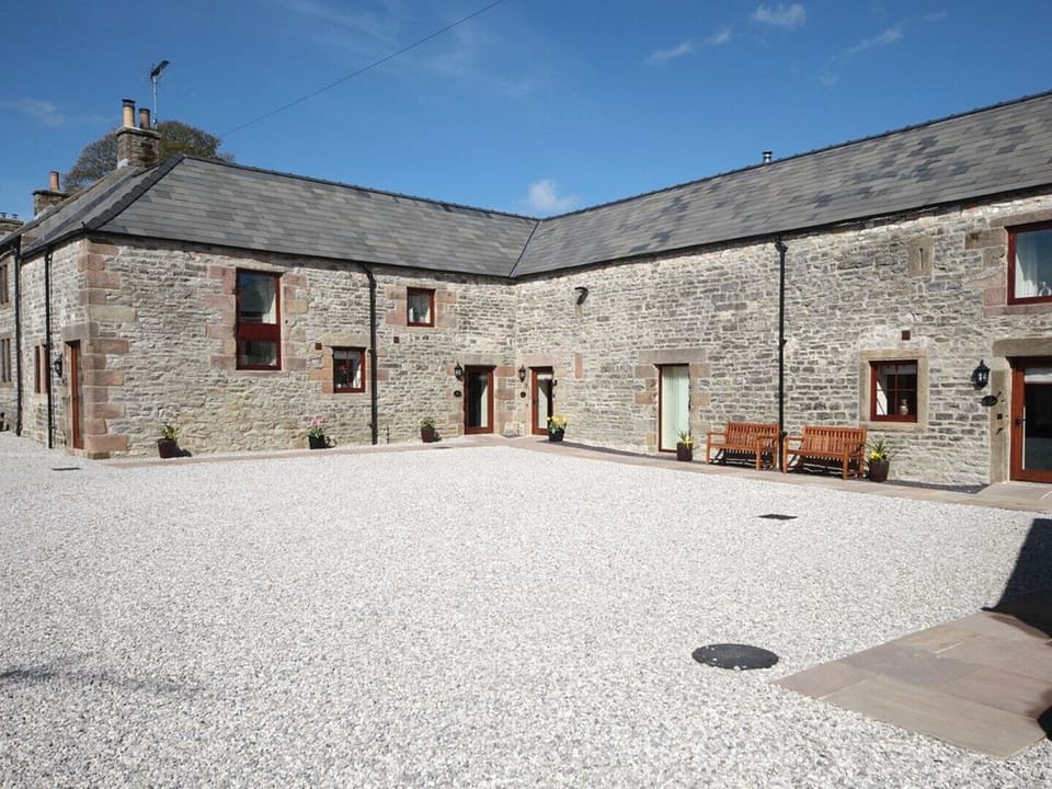 In a courtyard setting, The Farriers in the corner plot. 