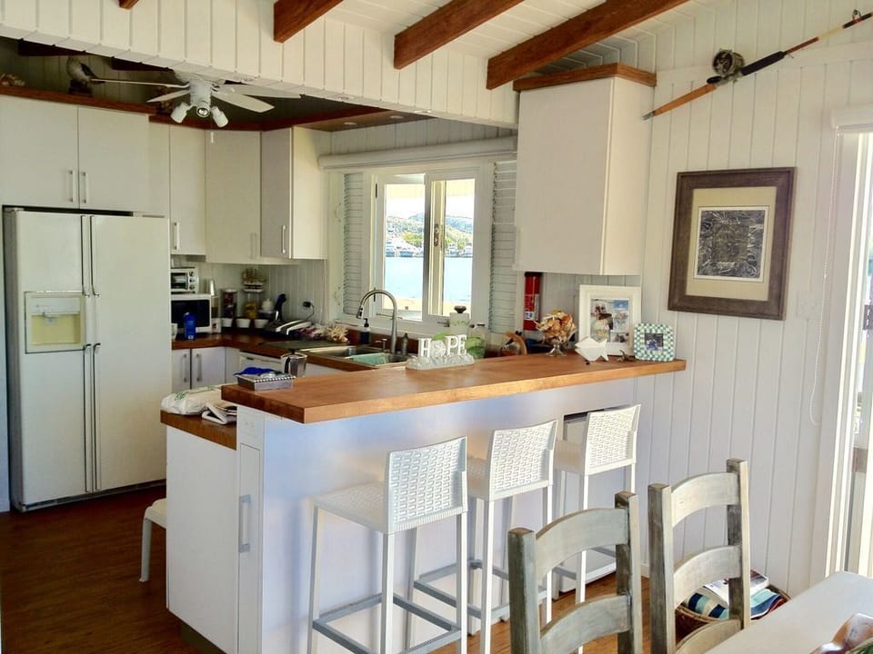Spacious kitchen with stove, oven, fridge with freezer and many amenities.
