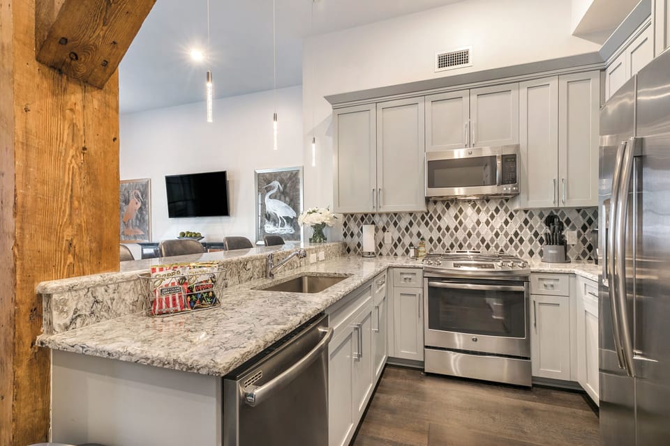 Cook and dine easily in the fully stocked kitchen, equipped with all stainless steel appliances, gas range, basic cookware, and a dining area for a comfortable meal at home. Entertain at the bar with seating for four.