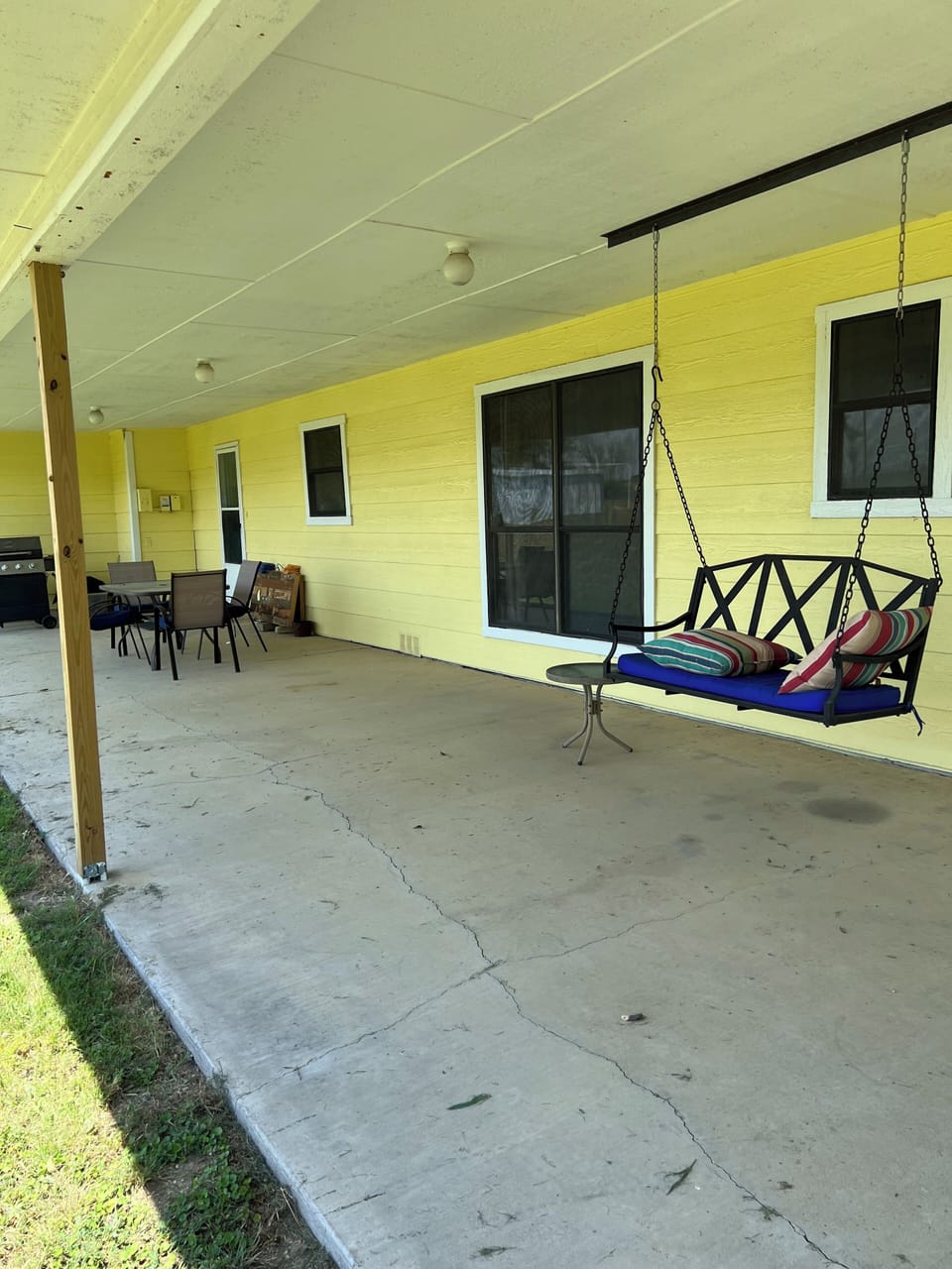 back porch with grill, eat outside or just enjoy a beverage on the swing