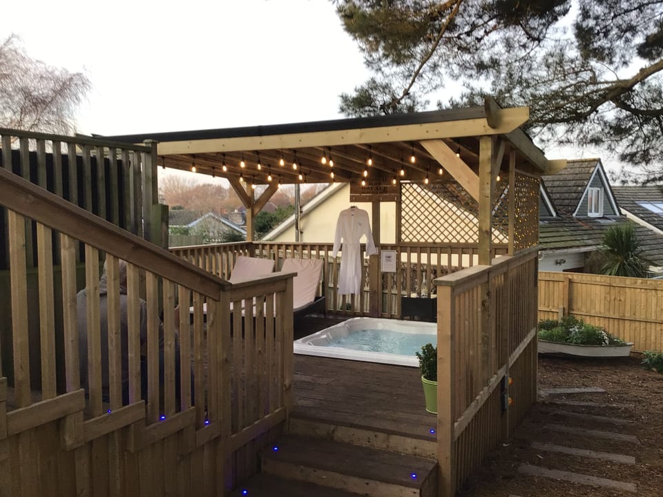 Tiered luxury quality decking leads down to secure garden