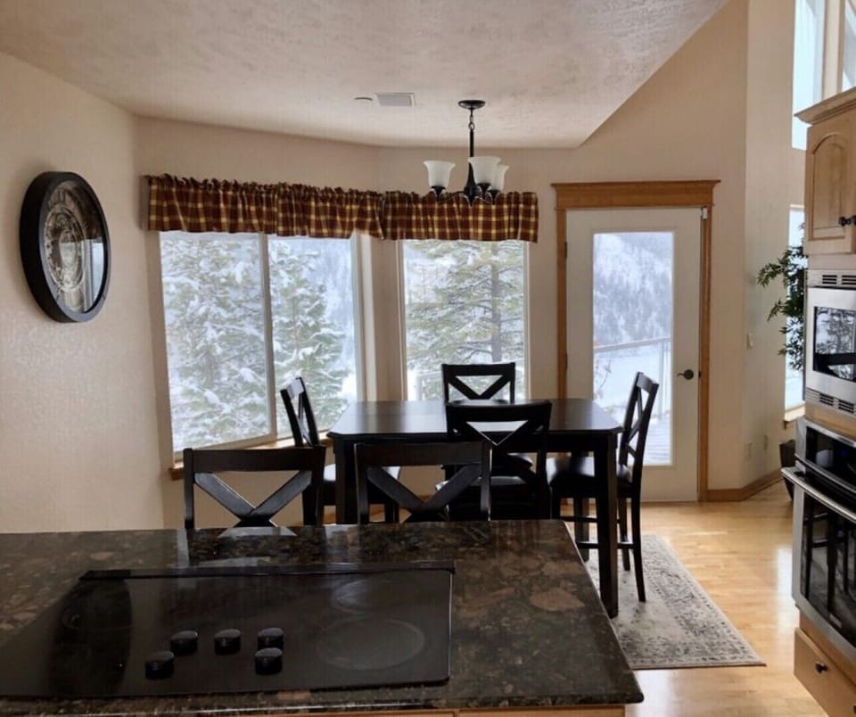 Second dining area in breakfast nook.  Kitchen has stove with hidden vent.