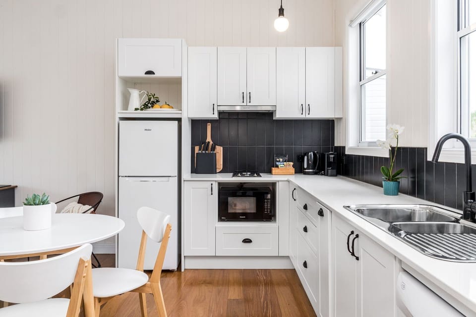 Kitchen with dishwasher and all plates, cooking utensils etc