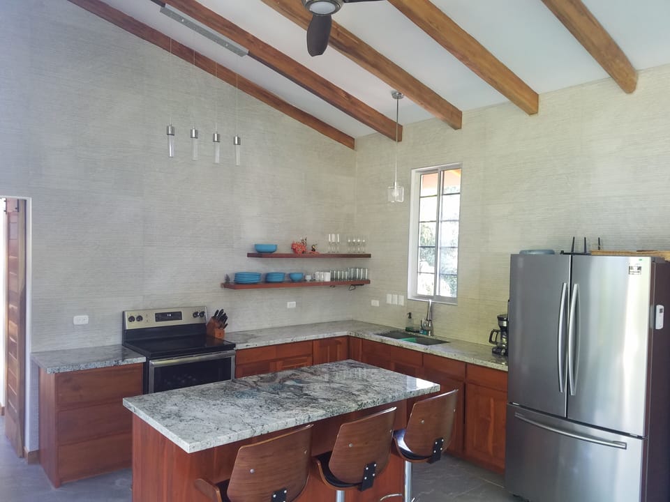 Nice kitchen with a granite island, perfect for cooking and gathering.