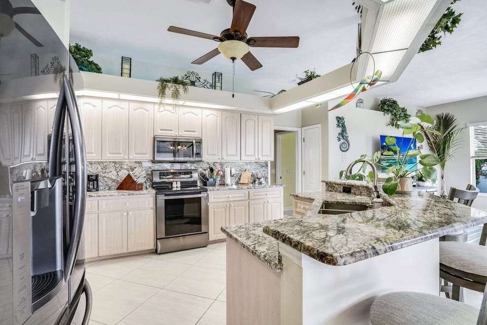 Open Concept Kitchen to living room and 4 breakfast bar stools