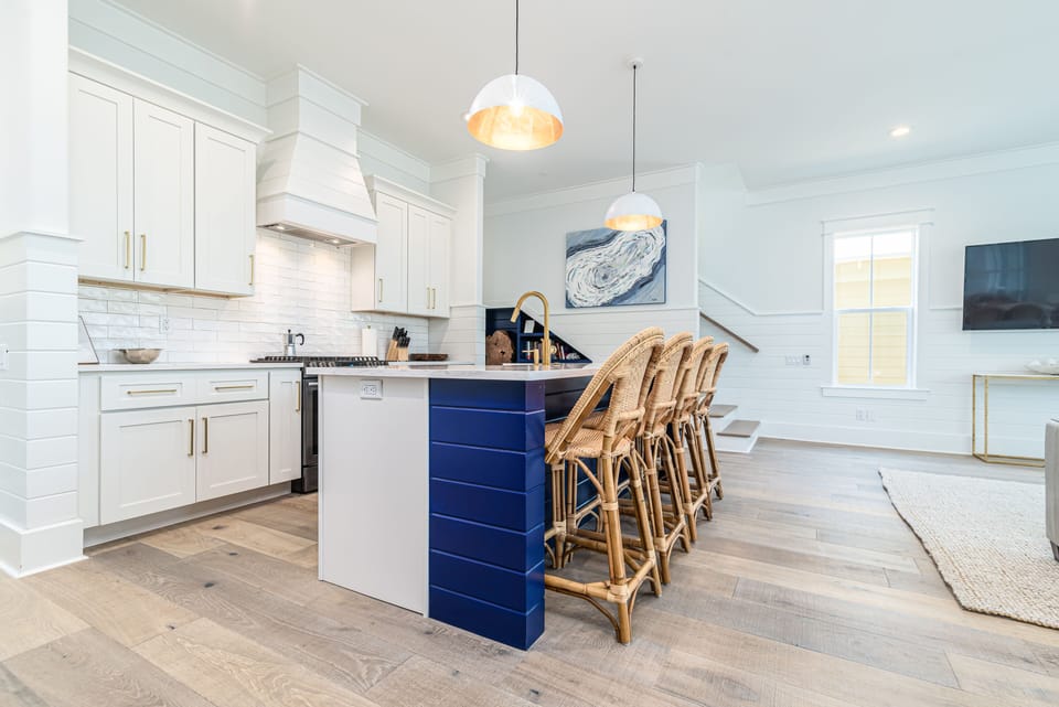 Kitchen features Brass Hardware, White Quartz Countertops, & Custom Cabinetry