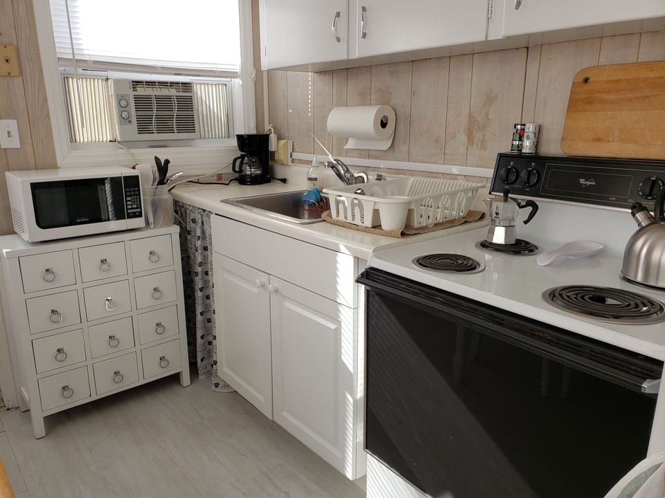 Kitchen with Stove/oven, microwave and refrigerator.