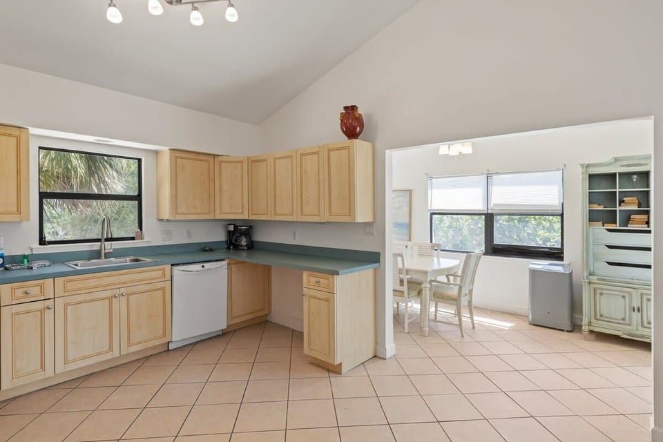 The dining table is adjacent to the kitchen, for easy dining