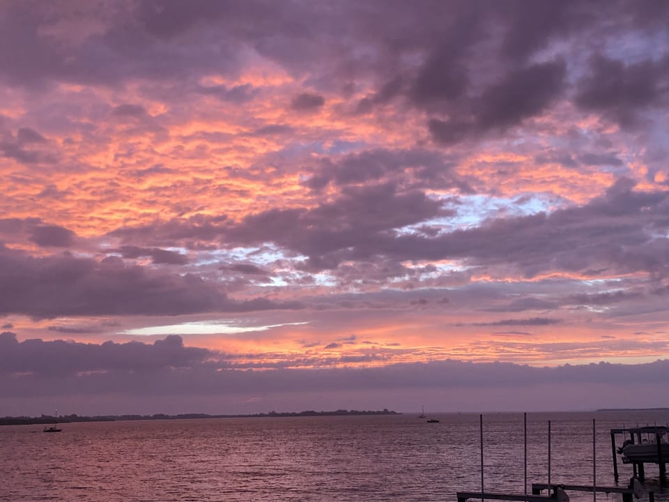 Sunrise over Sarasota Bay from inside home's kitchen + dining room