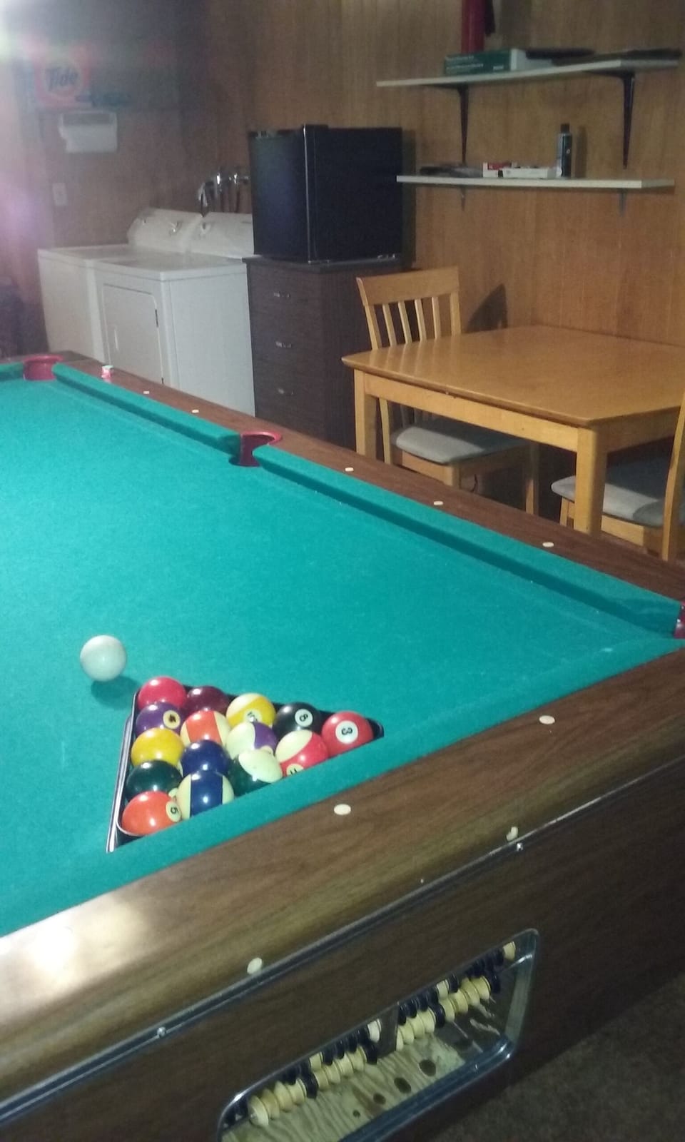 Downstairs pool table, washer, dryer, small table