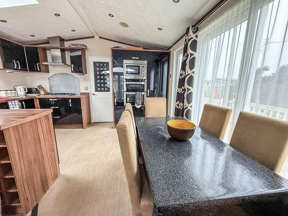 The adjacent dining table provides a dedicated space for everyone to sit down together, share food, and talk about their day.