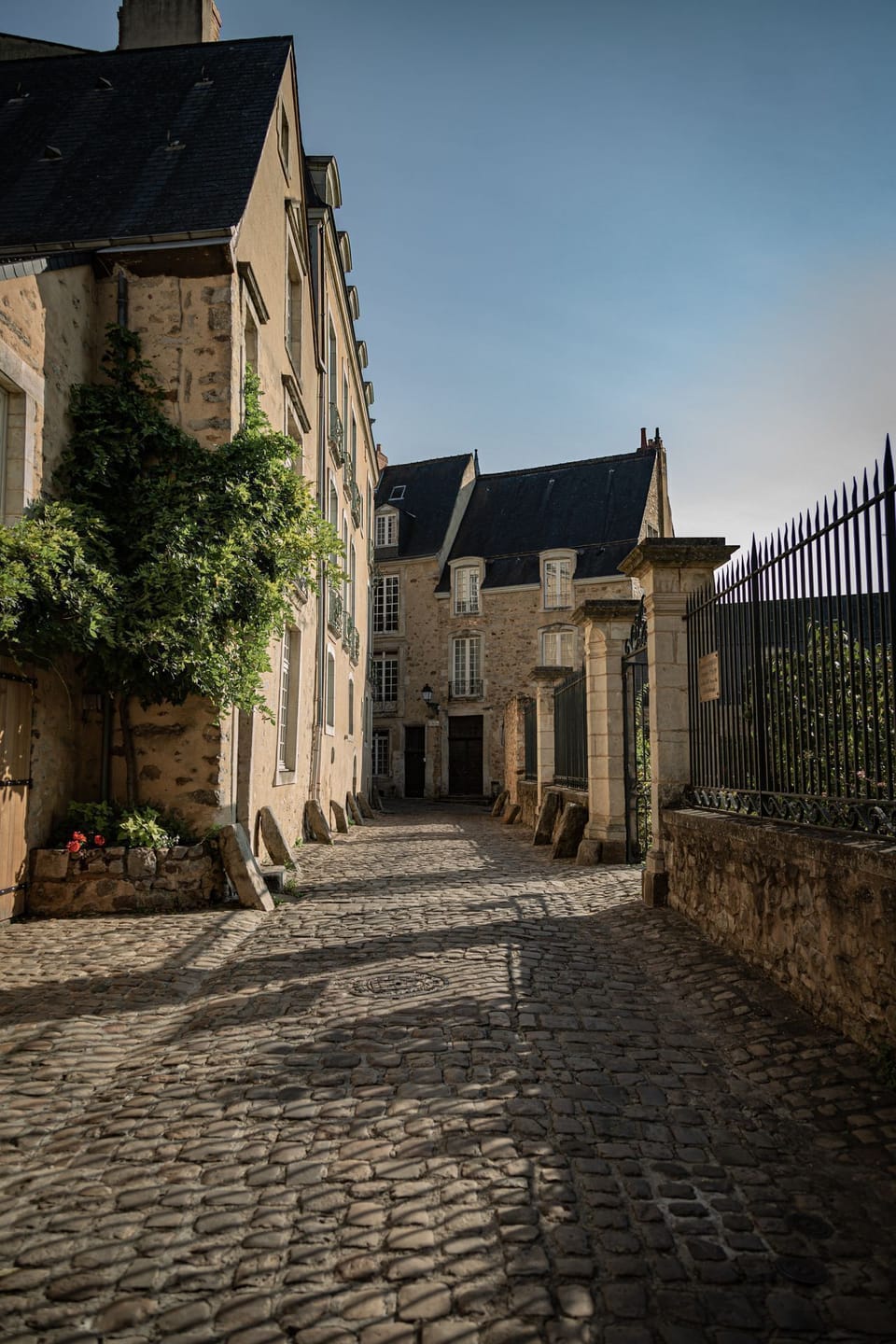 Sunlit cobbled lanes wind through Le Mans' remarkably preserved medieval old town, lined with honey-stone mansions and iron-gated courtyards.