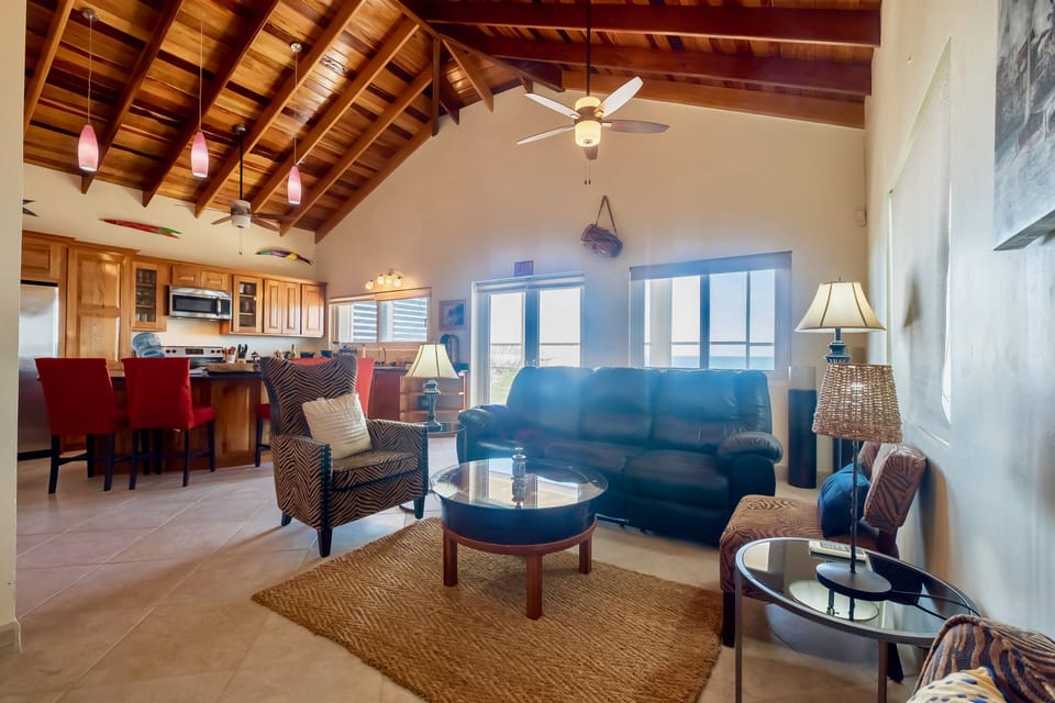 Living area with screened in porch just beyond couch