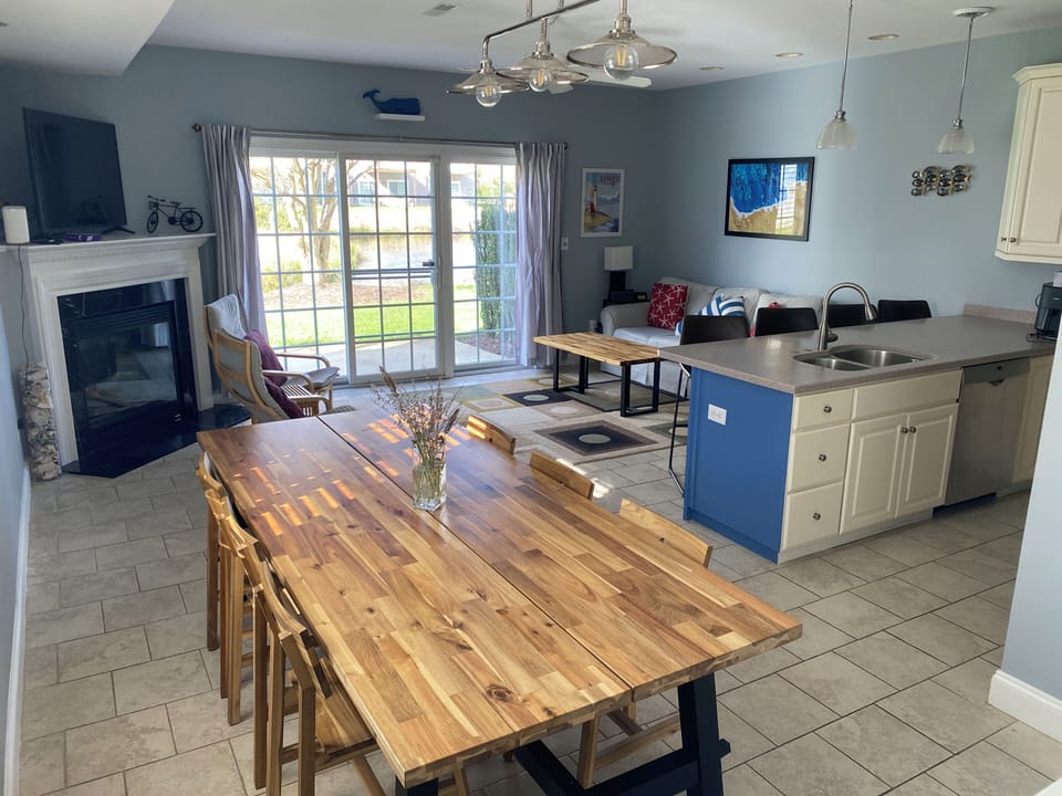 Dining, living & kitchen rooms in open layout, table with seating for nine