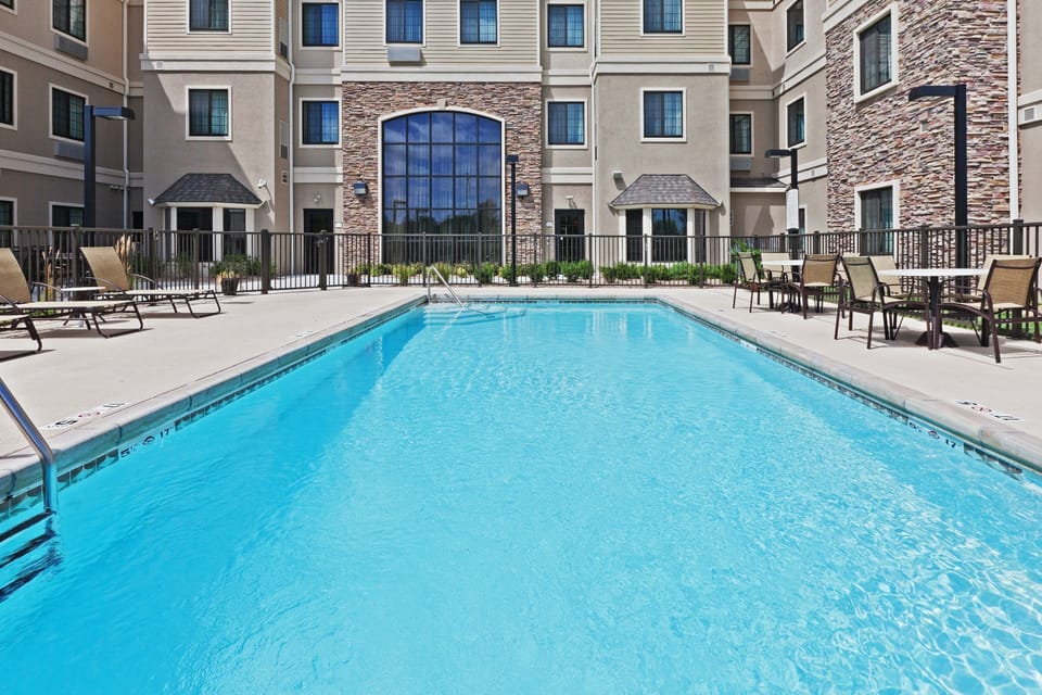 Outdoor pool surrounded by landscaping — open June through August for a midday refresh