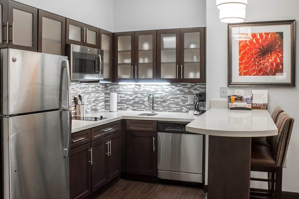 Prepare meals with ease in this modern kitchen, featuring sleek cabinets and stainless steel appliances that blend style with functionality.