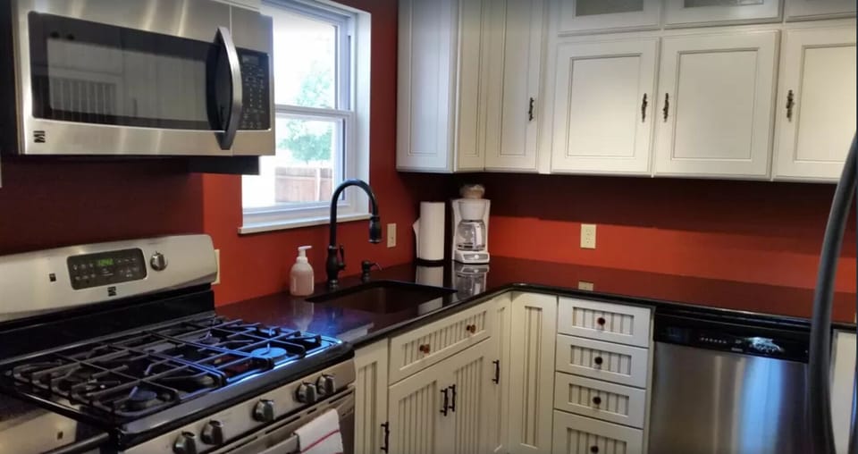 Fully equipped kitchen with stainless steel appliances.