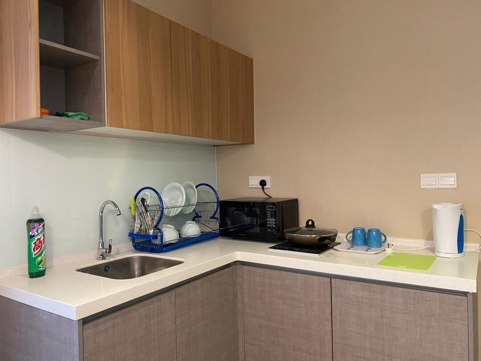 Kitchen includes water boiler, microwave, stove-top & pan, cutlery & mini-fridge