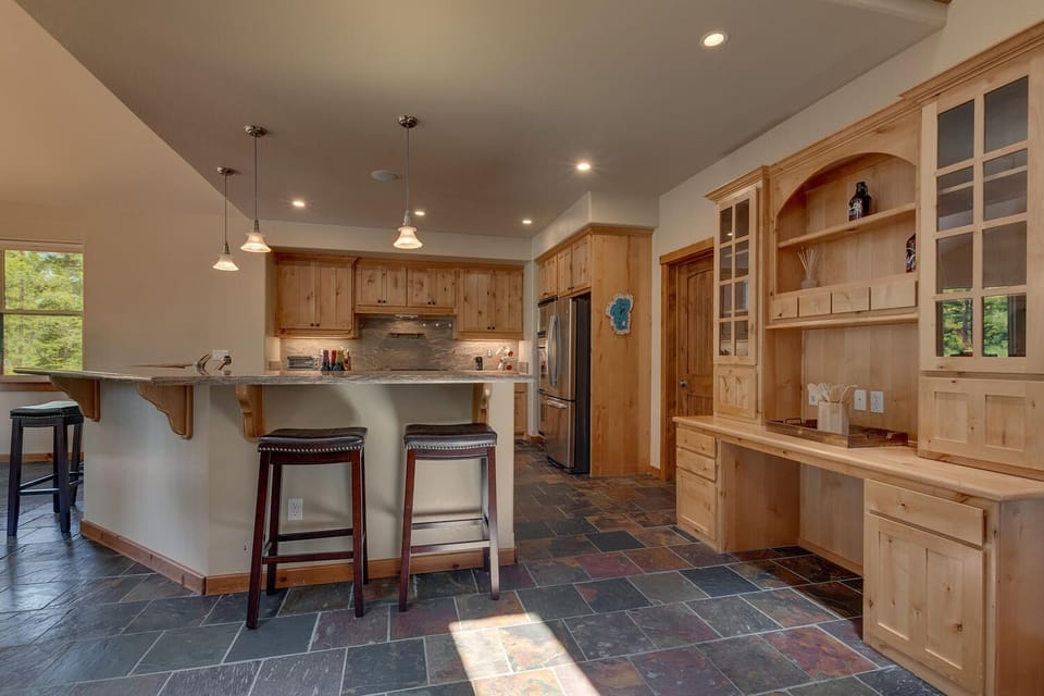 - Kitchen breakfast bar with seating  
- Rustic wood cabinetry and storage  
- Ideal cabin cooking and dining