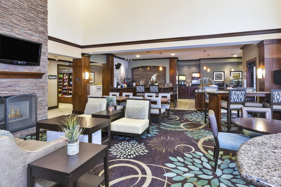 Relax by the cozy fireplace in the inviting community area, where comfort meets style in every detail.