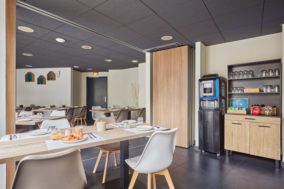 The bright dining space offers a perfect blend of comfort and style, where guests can unwind and enjoy breakfast with a taste of Marseille's charm.