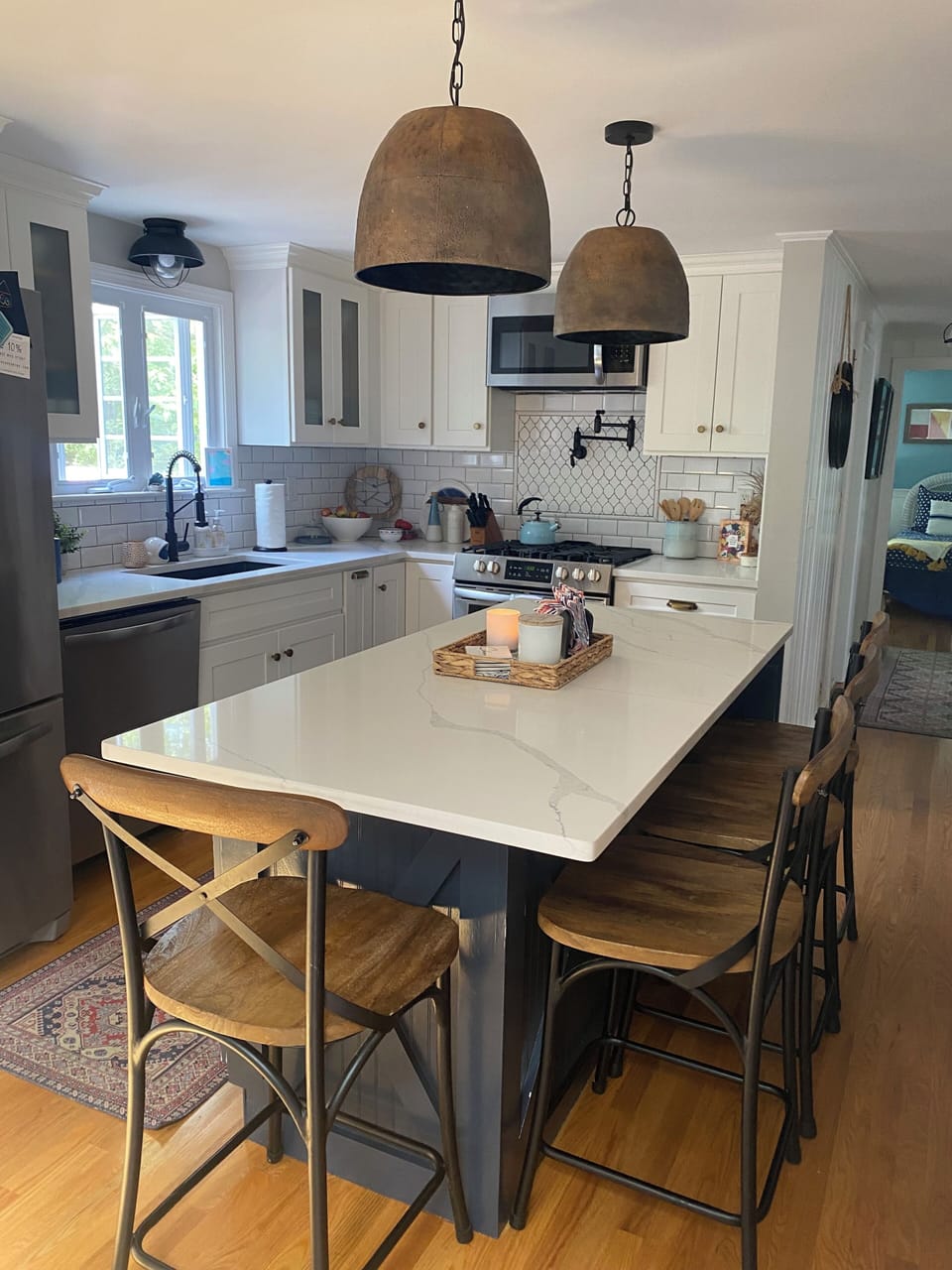 Kitchen includes gas stove, pot filler and island that seats 4