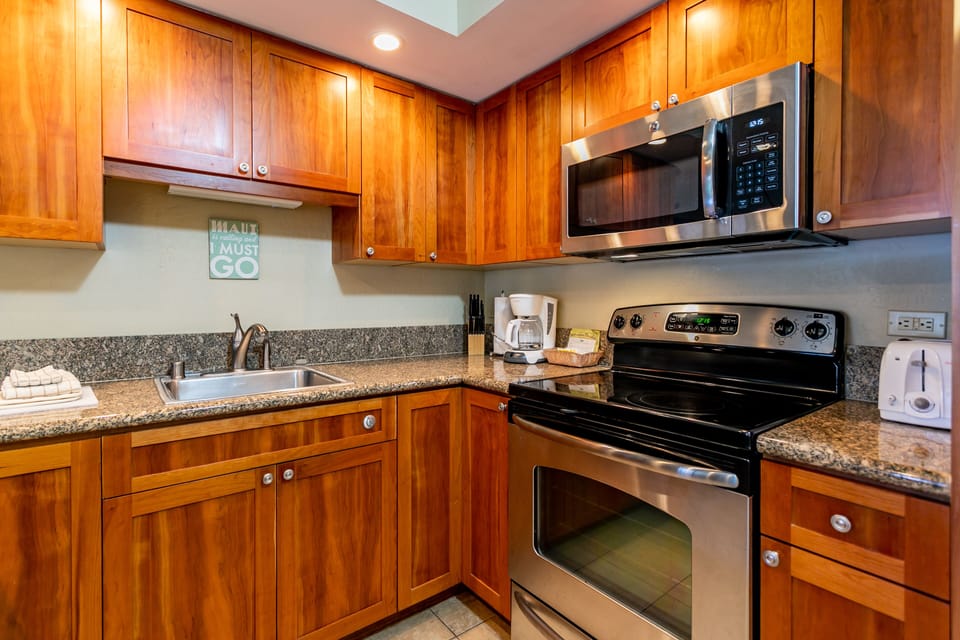 Step into your fully-equipped kitchen, where warm wood cabinetry and granite counters invite you to whip up meals just like home, complete with modern stainless appliances and all the essentials.