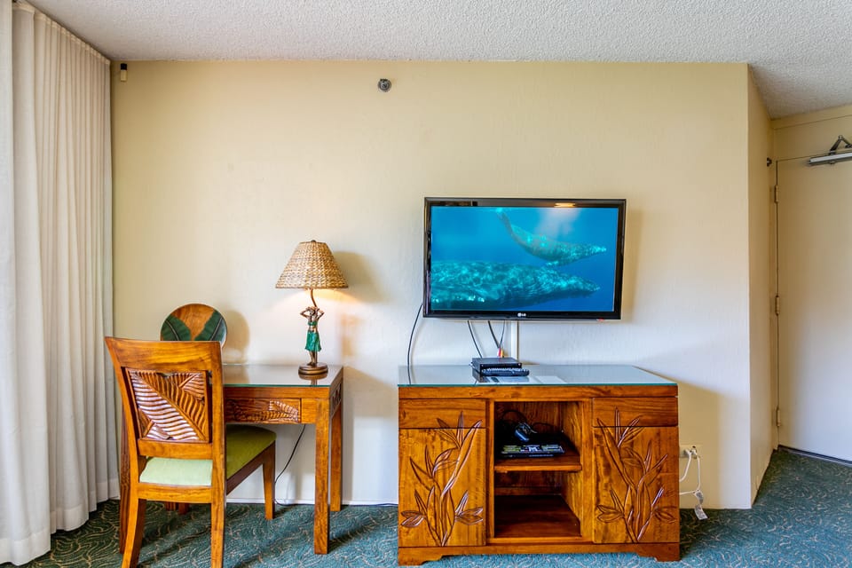 Your room features a flat-screen TV for entertainment, a cozy desk for catching up on work, and tropical-themed décor that brings island warmth to your stay.