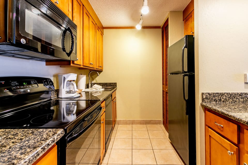 Your fully equipped galley kitchen features granite countertops, stainless steel appliances, and everything you need to prepare home-cooked meals during your stay.