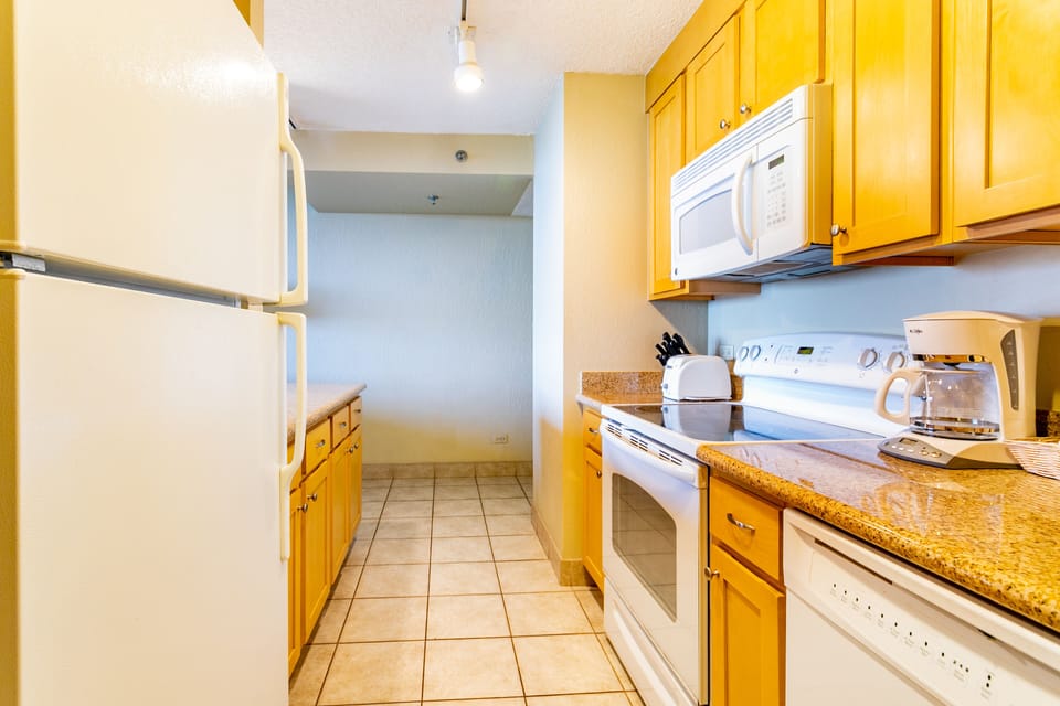 Your fully equipped kitchen features warm wood cabinetry and modern appliances, making it easy to whip up your favorite meals anytime.
