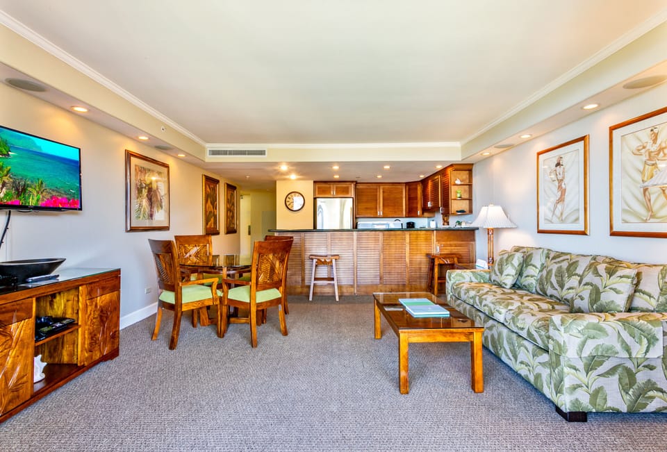 Step into your spacious tropical retreat featuring a bright, open living and dining area. Rich wood furnishings and lush botanical décor create a relaxing island atmosphere where you can unwind and feel right at home.
