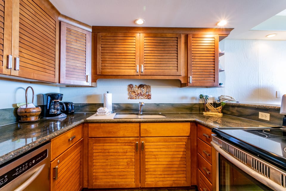 Your fully equipped kitchen awaits, with warm wood cabinetry, granite countertops, and all the essentials to prepare your favorite meals in comfort.