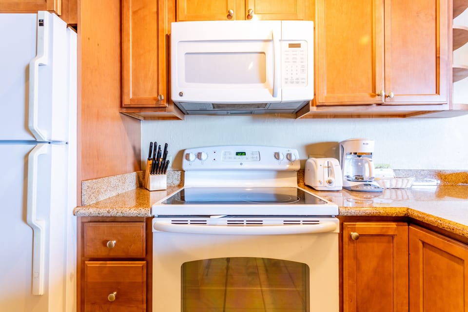 Your fully equipped kitchen features modern appliances and warm wood cabinetry, making meal prep a breeze during your stay.