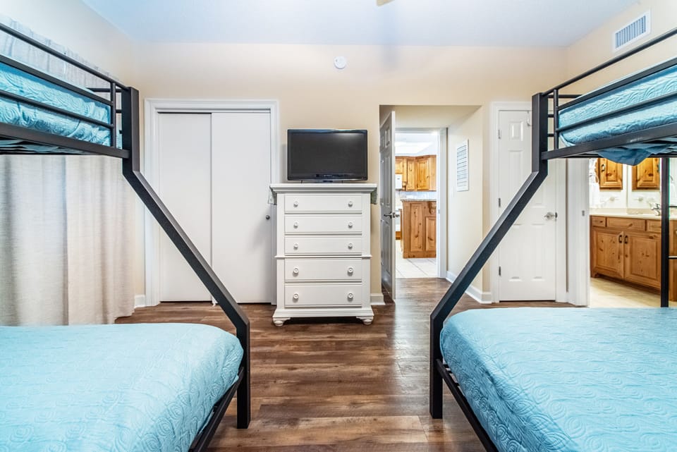 Bunk room with flat screen TV