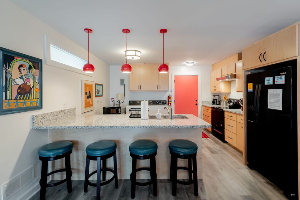 This kitchen is stocked with cookware, small appliances and utensils needed to cook and serve any meal.