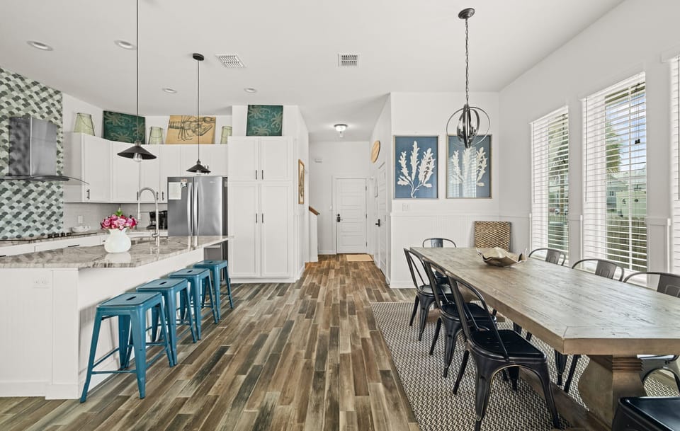 Kitchen & Dining — White Island, Teal Stools, Scallop Backsplash, Rustic Wood Table & Coral Art