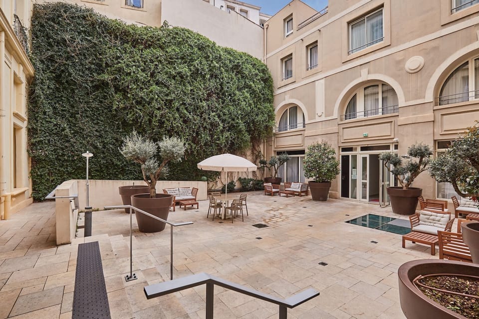 A charming inner courtyard with outdoor seating and lush greenery—perfect for a quiet retreat.