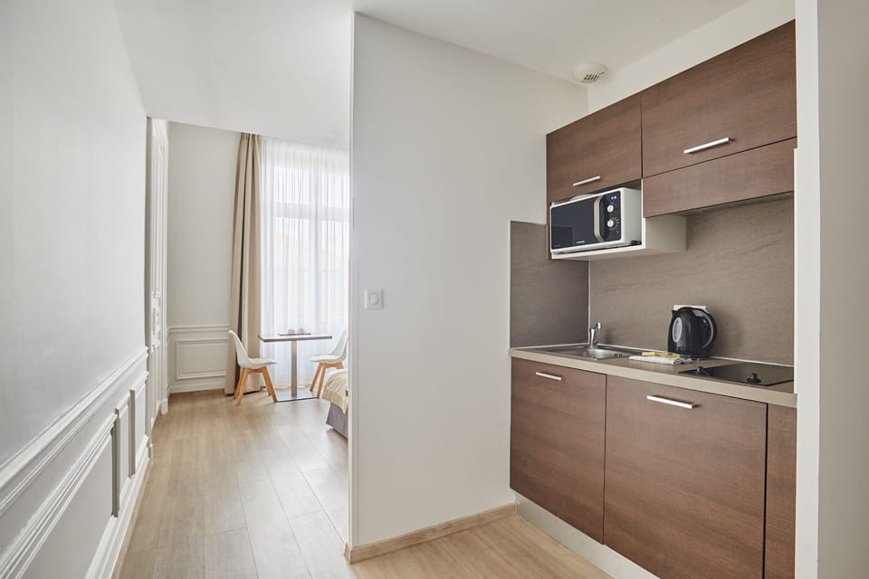 Handy in-room kitchenette with microwave, kettle, and essentials—perfect for longer stays.