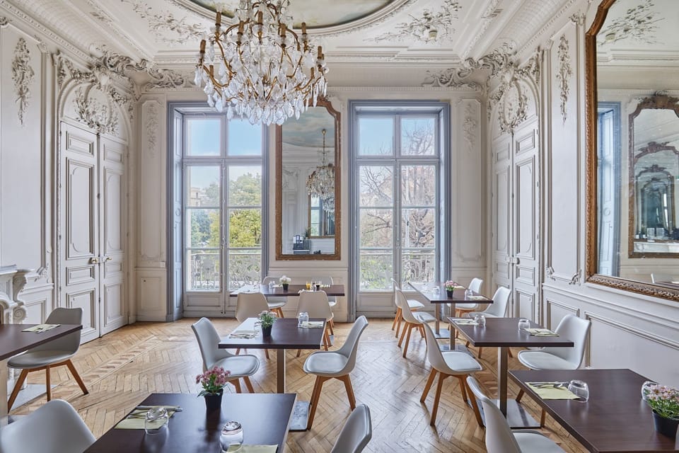Breathtaking salon adorned with period moldings, a gilded mirror, and refined seating—Montpellier elegance at its finest.