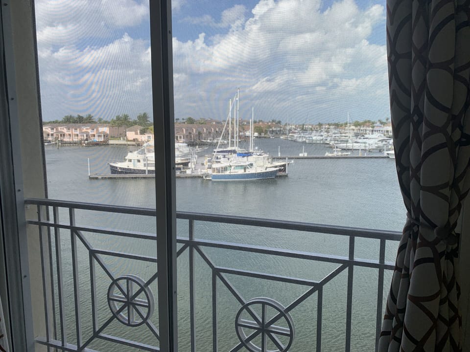 View of boats ,yacht basin and river from master bedroom screened in lanai