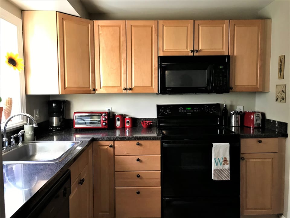 fully equipped kitchen with brand new flatware, dinnerware and glassware